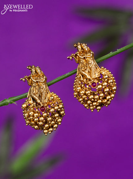 Antique earrings with ruby stones and golden beads hangings