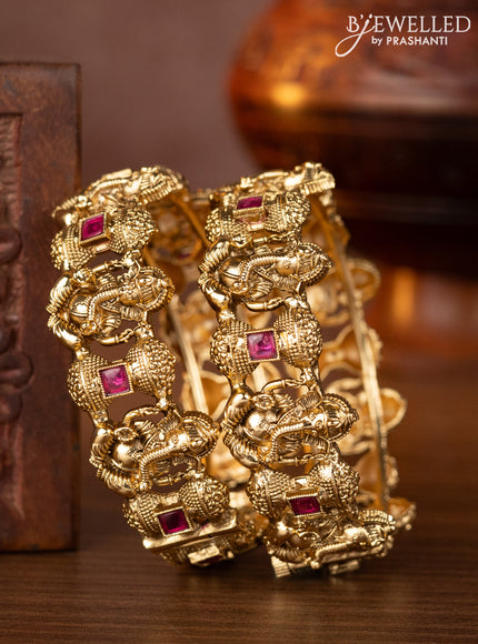 Antique screw type bangles with ganesha design and ruby stones