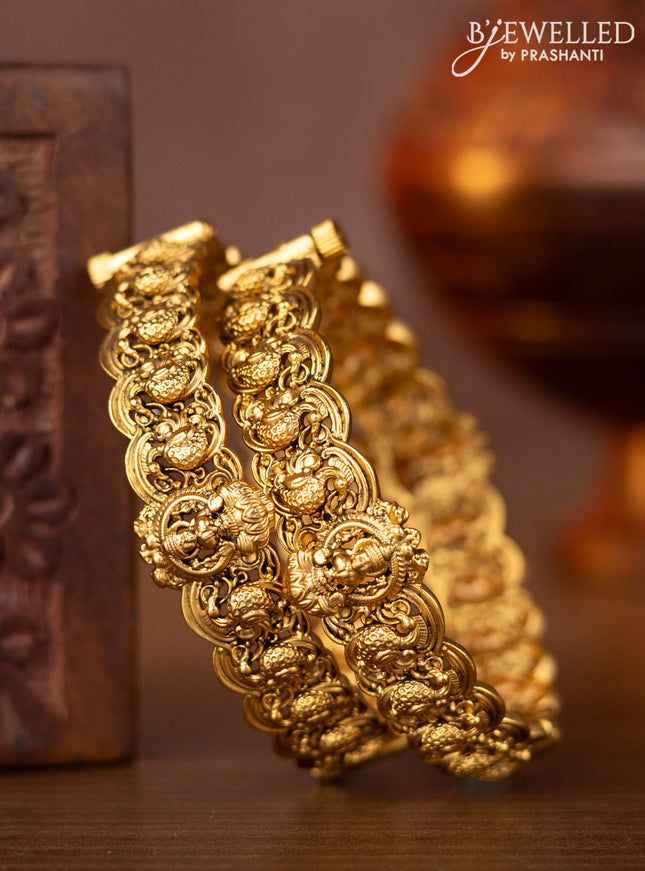 Antique screw type bangles with lakshmi and peacock design