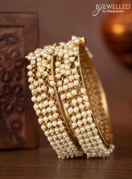 Antique screw type bangles with pearl hangings