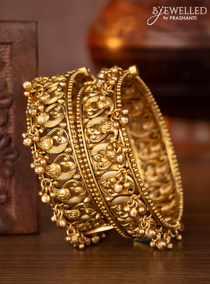 Antique screw type bangles with peacock design and golden beads hangings